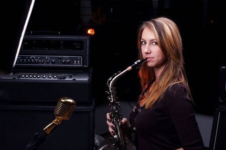 young female play in study on  saxophoneの写真素材
