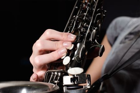 hand on buttons of saxophoneの写真素材