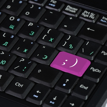 Computer keyboard with smile symbol on itの写真素材