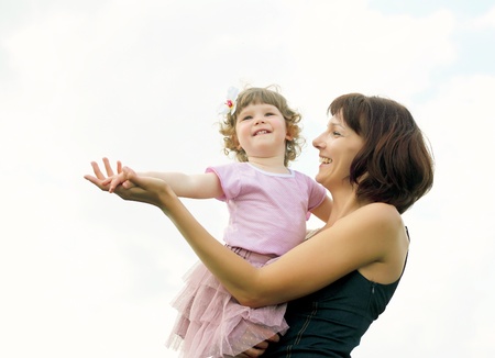 Portrait of mother with her little daughter outdoorの写真素材