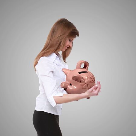 Collage with a piggybank and young business manの写真素材