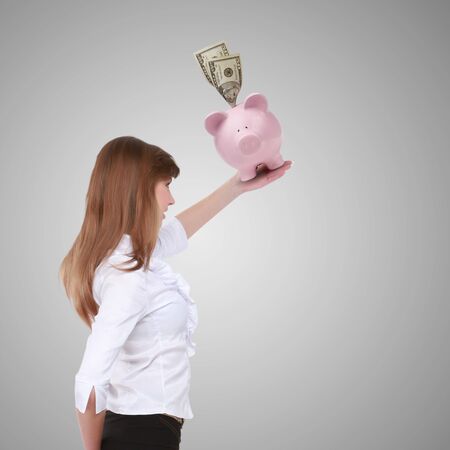 Collage with a piggybank and young business manの写真素材