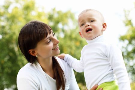 Young mother with her little son in summer parkの写真素材