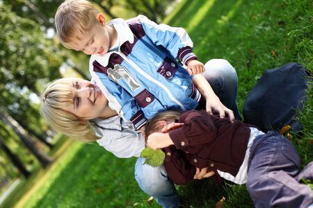 Young mother with her little son in summer parkの写真素材