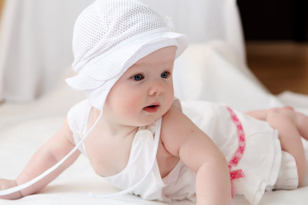portrait of cute little baby in a funny hatの写真素材