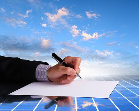 Image of a businessman hand signing documentsの写真素材