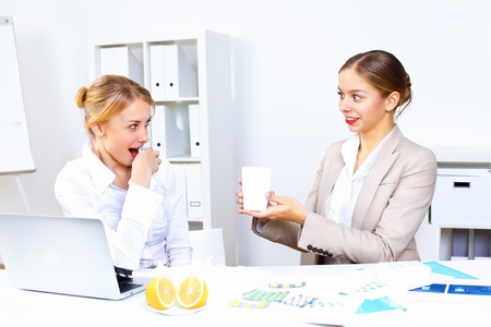 Young woman feeling unwell and sick in officeの写真素材