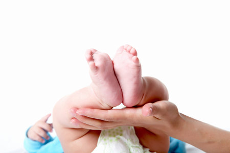 closeup of a mother hand holding baby feet