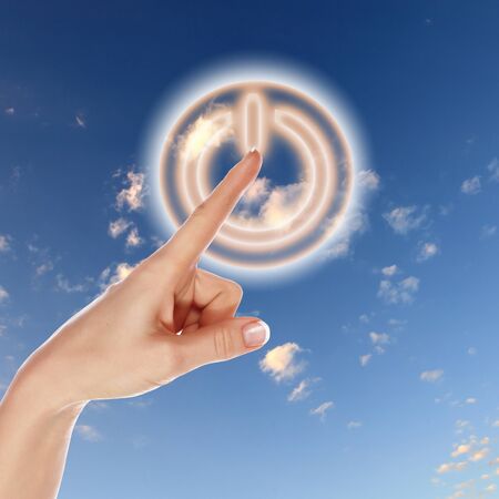 Picture of power button against blue sky backgroundの写真素材