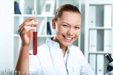 Young scientist in white uniform working in laboratoryの写真素材
