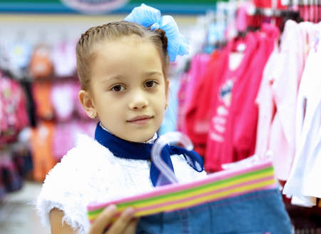 Young woman doing shopping and choosing clothesの写真素材