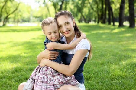 Mother with her daughter outside in the summer parkの写真素材