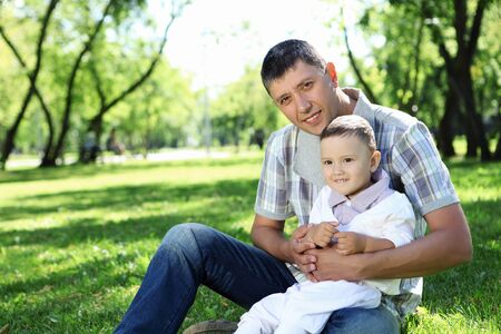 Father with his baby boy outside in the parkの写真素材