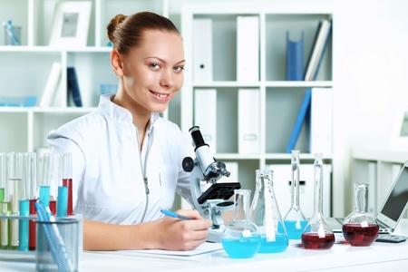 Young scientist in white uniform working in laboratoryの写真素材