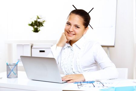POrtrait of a young beautiful woman in business wear at workの写真素材