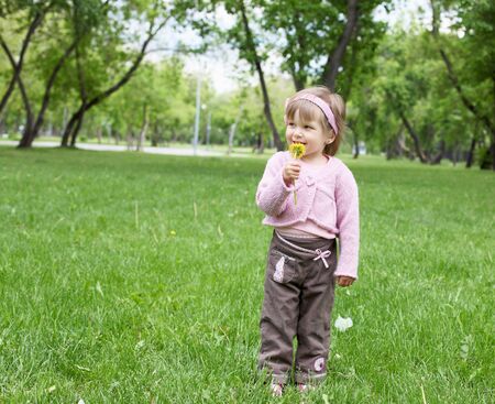 Portrait of a happy little girl in the parkの写真素材