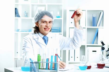 Young scientist in white uniform working in laboratoryの写真素材