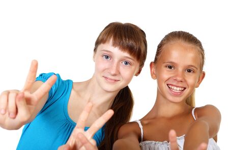 two teenage girls together in studio against white backgroundの写真素材
