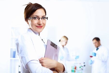 Scientist in uniform doing tests in laboratoryの写真素材