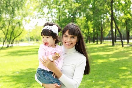 Mother with her daughter outside in the summer parkの写真素材