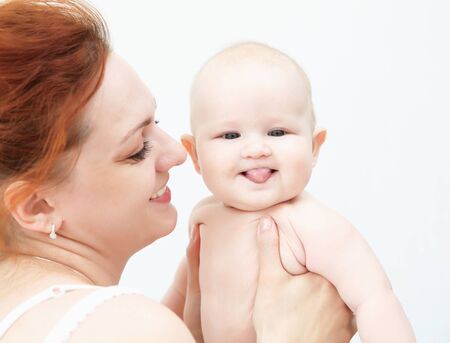 Portrait of a young child and his mother a white background  Baby の写真素材