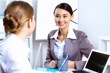 Young women in business wear working in office togetherの写真素材