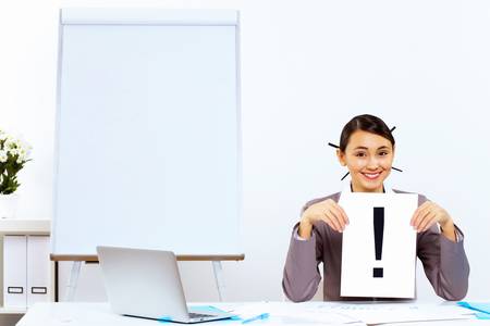 Young woman in business wear generating ideas in officeの写真素材