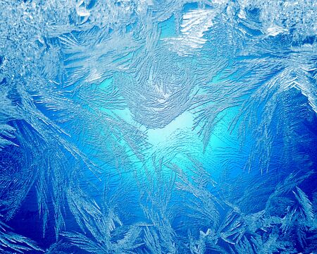 Blue frost winter background with white snowflakesの写真素材