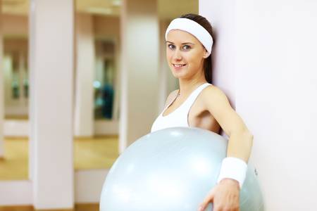 Young woman in sport wear doing sport in gymの写真素材