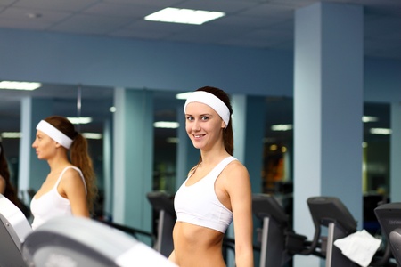 Young woman in sport wear doing sport in gymの写真素材
