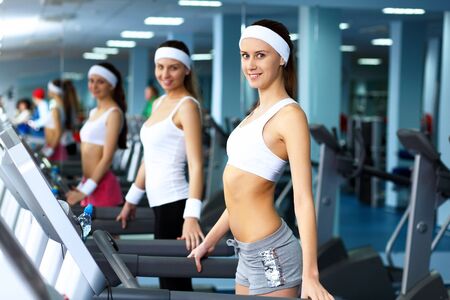 Young woman in sport wear doing sport in gymの写真素材