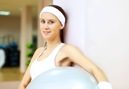 Young woman in sport wear doing sport in gymの写真素材