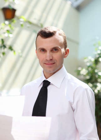 young business man working with documents in gardenの写真素材