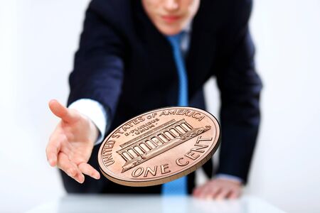 Person throwing a coin as symbol of risk and luckの写真素材