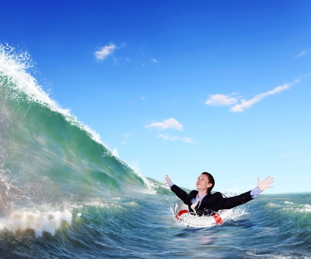 Image of a businessman surfing on the sea wavesの写真素材