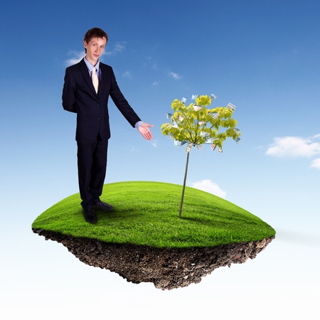Collage with a money tree and young business manの写真素材