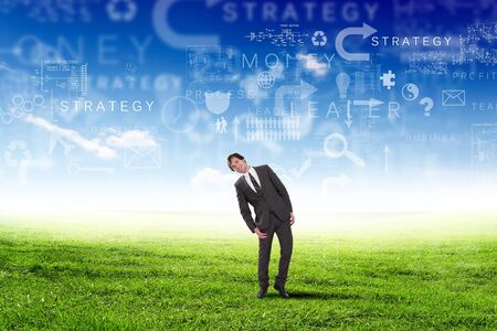 Young businessman outdoor with business symbols on the sky backgroundの写真素材