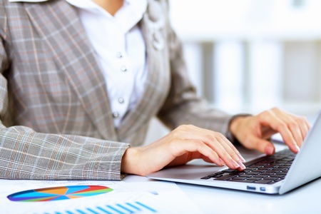 Young blond woman in business wear in office environmentの写真素材