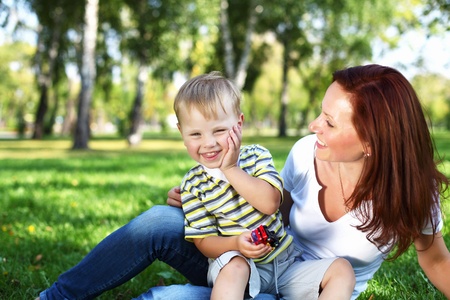 Young mother with her little son in summer parkの写真素材