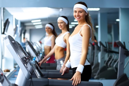 Young woman in sport wear doing sport in gymの写真素材