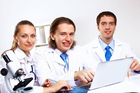 Group of doctors in uniforms together in clinicの写真素材