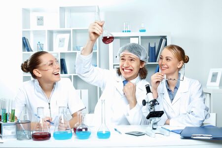 Young scientists in white uniform working in laboratoryの写真素材