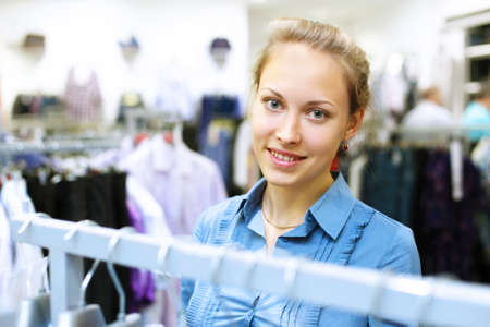 Young woman in a shop buying clothesの写真素材