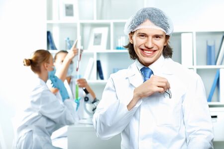 Young scientists in white uniform working in laboratoryの写真素材