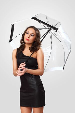Studio portrait of woman in black dress with umbrellaの写真素材