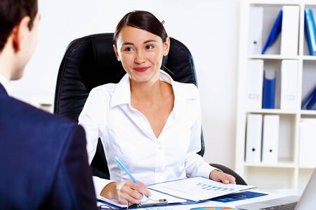 Portrait of young woman in business wear in officeの写真素材