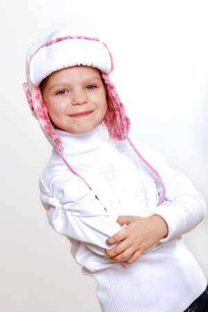 Portrait of little kid in winter wear against white backgroundの写真素材