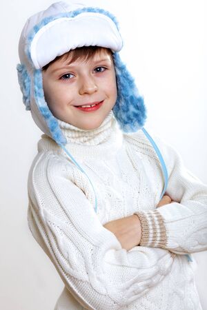 Portrait of little kid in winter wear against white backgroundの写真素材