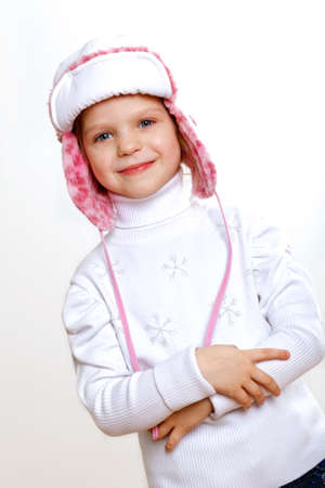 Portrait of little kid in winter wear against white backgroundの写真素材