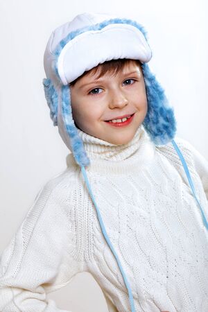 Portrait of little kid in winter wear against white backgroundの写真素材